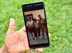 caroline mukiza wife to the deceased soldier mr edison kamwesigye in russia holds a portrait of the late husband outside st augustine chapel at makerere university in kampala uganda on february 10 2026