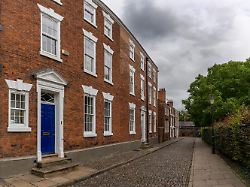 chester united kingdom 26 august 2022 red brick buildings with colorful doors in typical english fashion in the historic city center of chester