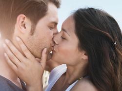 couple sharing a romantic kiss outdoors on the beach in majorca model released symbolfoto westf017127
