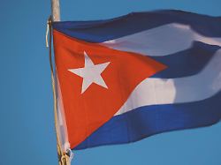 cuba flag waving on wind against deep blue sky cuban flag main symbol of cuba natural textile cuban flag flutters in the wind of freedom against blue sky sea breeze in cuba