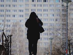 die silhouette einer frau zeichnet sich ab vor wohnbloecken im berliner bezirk marzahn aufgenommen in berlin 19 02 2026