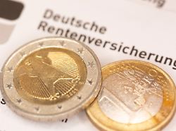 euromuenzen liegen auf einem schreiben der deutschen rentenversicherung