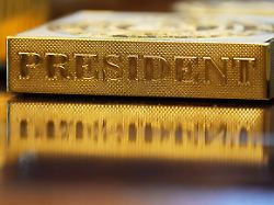 file a gold colored item embossed with the word president sits on the resolute desk in the oval office of the white house in washington nov 10 2025