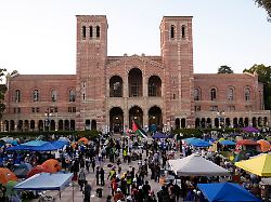file demonstrators walk in an encampment on the ucla campus after clashes between pro israel and pro palestinian groups may 1 2024 in los angeles ap photo jae c