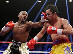 file floyd mayweather jr left hits manny pacquiao from the philippines during their welterweight title fight on may 2 2015 in las vegas