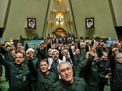 february 1 2026 tehran iran iranian lawmakers wearing islamic revolutionary guard corps irgc uniforms chant slogans during a session of parliament in tehran