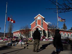 february 14 2026 tumbler ridge bc canada people pay their respects at a memorial on the steps of the town hall following a vigil the previous day in tumbler ridge b c saturday feb 14 2026