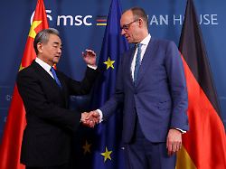 german chancellor friedrich merz right shakes hands with chinese foreign minister wang yi as they meet during the munich security conference msc in munich germany saturday feb 14 2026