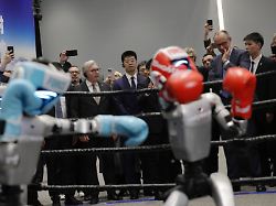 german chancellor friedrich merz watches a humanoid robot boxing as he visits the unitree robotics headquarters during his official visit in hangzhou china thursday feb 26 2026