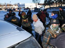 ice agents detain a man during an operation by us immigration and customs enforcement ice and border patrol in st paul minnesota on january 27 2026