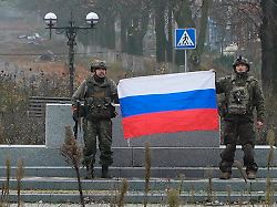 in this image made from video provided by russian defense ministry press service on tuesday dec 2 2025 russian soldiers hold a russian national flag in pokrovsk a city in the donetsk region ukraine