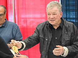 july 6 2025 montreal pq canada actor william shatner hands a signed captain kirk figure back to a fan during a meet and greet session at comiccon in montreal sunday july 6 2025