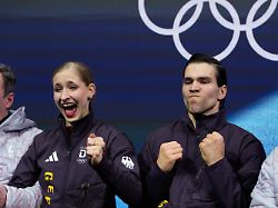 minerva fabienne hase and nikita volodin of germany react to their scores after competing during the pairs figure skating short program at the 2026 winter olympics in milan italy sunday feb 15 2026
