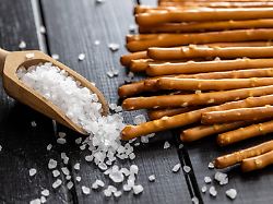 salty sticks crunchy pretzels and coarse salt in wooden scoop salty sticks crunchy pretzels and coarse salt in wooden scoop copyright xzoonar