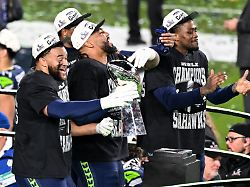 seattle seahawks teammates hold the vince lombardi trophy after winning super bowl lx against the new england patriots 29 13 at levi s stadium in santa clara california on sunday february 8 2026