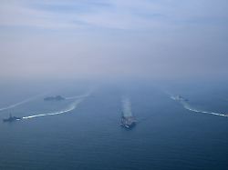 the u s navy s nimitz class aircraft carrier uss abraham lincoln leads its strike group during a photo exercise in the arabian sea february 6 2026 u s