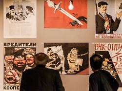 visitors look soviet propaganda banners of 30 s in a exhibition of the gulag history museum in moscow russia on 21 may 2018