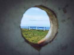 a blue and white bench on the cliffs of kilkee county clare ireland