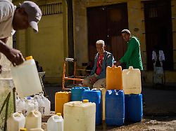 a man fill containers with potable water during a blackout in havana sunday march 22 2026
