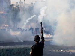 a police officer fires a teargas shell to disperse a protest outside the u s and israeli strikes on iran that killed iran s supreme leader ayatollah ali khamenei in karachi pakistan march 1 2026