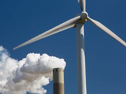 climate change heaven and hell of a wind turbine with emissions from a coal fired power station in amsterdam netherlands