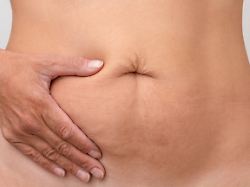 cropped woman hand on right side of stomach to show pain or symptom there 48871732