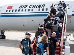 daily life in beijing china 12 apr 2025 flight passengers ascend the boarding stairs also known as a boarding ramp to board an air china plane on the runway at beijing international airport in china