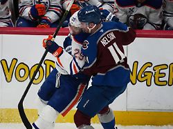 edmonton oilers center leon draisaitl left is checked off the puck by colorado avalanche center brock nelson in the first period of an nhl hockey game tuesday march 10 2026 in denver