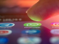 finger ueber dem smartphone kurz vorm oeffnen einer messenger app finger via the smartphone briefly vorm open a messenger app 1047101653