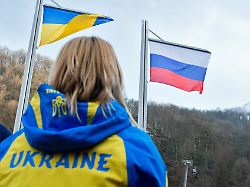 flags of the ukraine l and russia are seen during the medal ceremony for the women s 12km sitting cross country event at the sochi 2014 paralympic winter games krasnaya polyana russia 10 march 2014 2