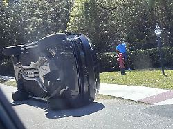 golfer tiger woods stands by his overturned vehicle in jupiter island fla on friday march 27 2026