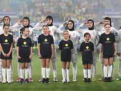 iran players react during their national anthem ahead of the women s asia cup soccer match between australia and iran in robina australia thursday march 5 2026 1