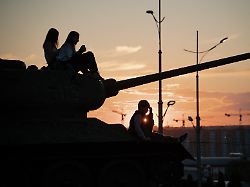local residents sit on a monument of t 34 tank from the second world war as they celebrate ukraine s independence day in kharkiv on august 24 2025 amid the russian invasion of ukraine