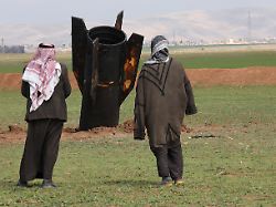 people stand next to an iranian missile after it fell near qamishli international airport amid the u s israeli conflict with iran in qamishli syria march 4 2026