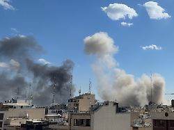 plumes of smoke rise after a strike in tehran iran sunday march 1 2026