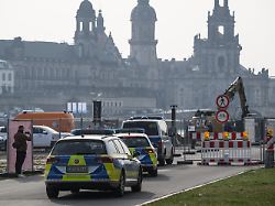 polizisten fahren zur baustelle an der abgerissenen carolabruecke wegen der moeglichen weltkriegsbombenfunde an der ehemaligen dresdner carolabruecke kann es zu einer evakuierung kommen