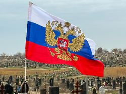 russian flag waving over an orthodox cemetery donetsk oblast mariupol ukraine