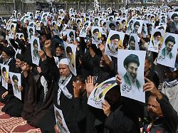 schiitische muslime halten plakate mit dem bild des modschtaba chamenei und seines verstorbenen vaters ajatollah ali chamenei um ihre unterstuetzung waehrend einer prozession in karachi zu zeigen 1