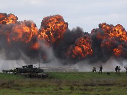 smoke billows from a blast near polish abrams tank as polish forces with nato soldiers hold military exercises iron defender at a military range in wierzbiny near orzysz poland september17 2025