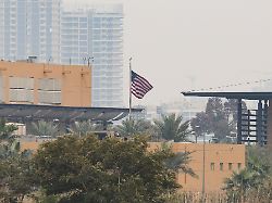 the u s flag flies at the u s embassy after iraqi security sources said the embassy was hit in a missile attack in baghdad iraq march 14 2026