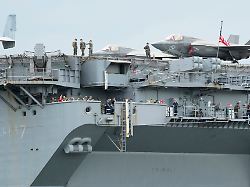 u s personnel stand beside an f 35b lightning ii aircraft on board the u s navy uss tripoli lha 7 amphibious assault ship during a port call in manila philippines tuesday sept 27 2022