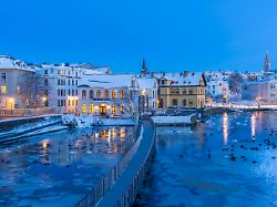 view of waterfront buildings and city skyline in background in the city centre of reykjavik at dusk in winter reykjavik iceland