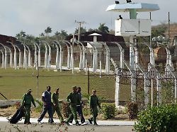 epa03655941 several soldiers escort two inmates at prison combinado del este during a visit of national and foreign journalists in havana cuba 09 april 2013 the jail held an open day for media 1