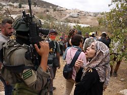 a palestinian woman speaks to an israeli soldier in the village of edna north of the occupied west bank city of hebron during the olive harvesting season on october 12 2025