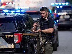 an armed police officer prepares near the scene of shooting at the emory university in atlanta on friday aug 8 2025