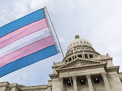 april 4 2026 a person flies a transgender pride flag outside the idaho capitol during a trans day of visibility rally on march 31 2026 in boise idaho credit image sarah a