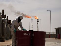 ein arbeiter steht an oeltonnen waehrend er an einer entgasungsstation im zubair oelfeld in der naehe von basra arbeitet der betrieb auf dem oelfeld ist aufgrund des iran kieges eingeschraenkt