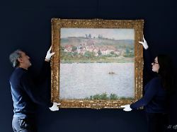 employees of the sotheby s auction house handle the painting vetheuil effet du matin 1901 by french impressionist painter claude monet at the sotheby s auction house in paris france april 16 2026