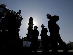 file saudi aramco engineers walk in front of a gas turbine generator at khurais oil field during a tour for journalists outside of riyadh saudi arabia on june 28 2021