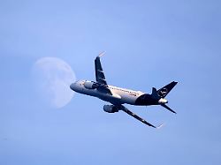 francois glories maxppp 17 07 2024 an airbus a320 belonging to the german airline lufthansa passed through a waxing gibbous moon on its way from nice to frankfurt in germany
